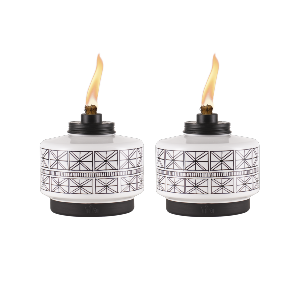 Two TIKI Brand table torches with geometric black-and-white patterns and visible flames, ideal for outdoor ambiance.