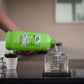 Green TIKI Bite Fighter Torch Fuel being poured into a clear container.