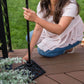 Black metal patio umbrella stand with decorative base.