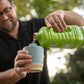 Green Tikki water bottle pouring into a light blue cup.