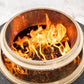 Portable fire pit with glowing flames and charcoal fuel.