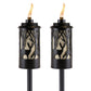 Black Tiki torches with deer and tree designs, flame lit.