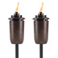 Bronze Tiki torches with flame, outdoor lighting.