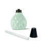 Mint green textured candle holder with black lid and wick.