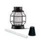 Black lantern with glass body and metal cage, includes white candle and base.