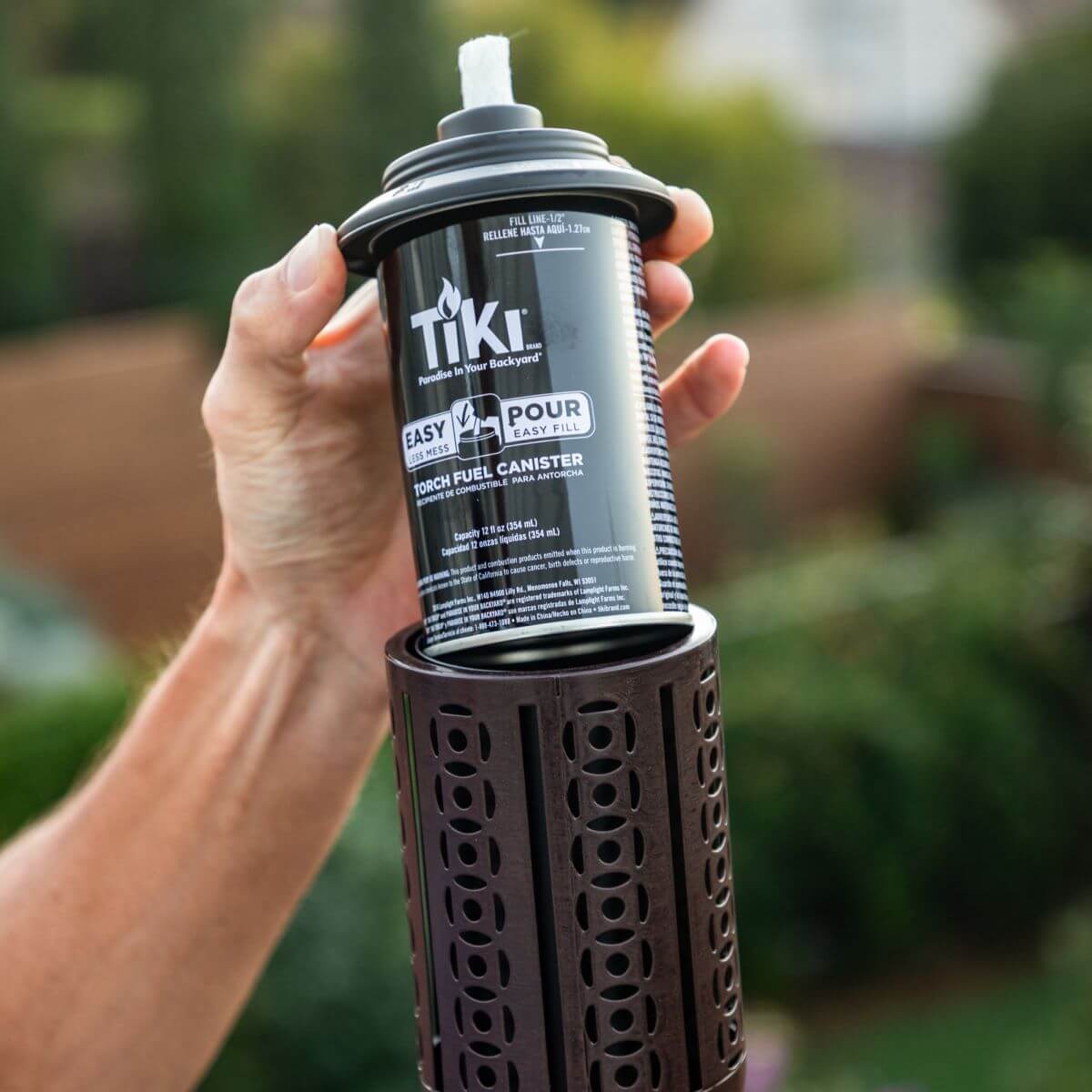 Black TIKI torch fuel canister with easy pour and fill design.
