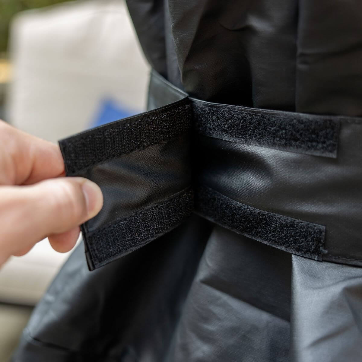 Black tactical pants with adjustable velcro straps for secure fit.