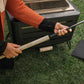 Black outdoor heater with adjustable handle, grass background.