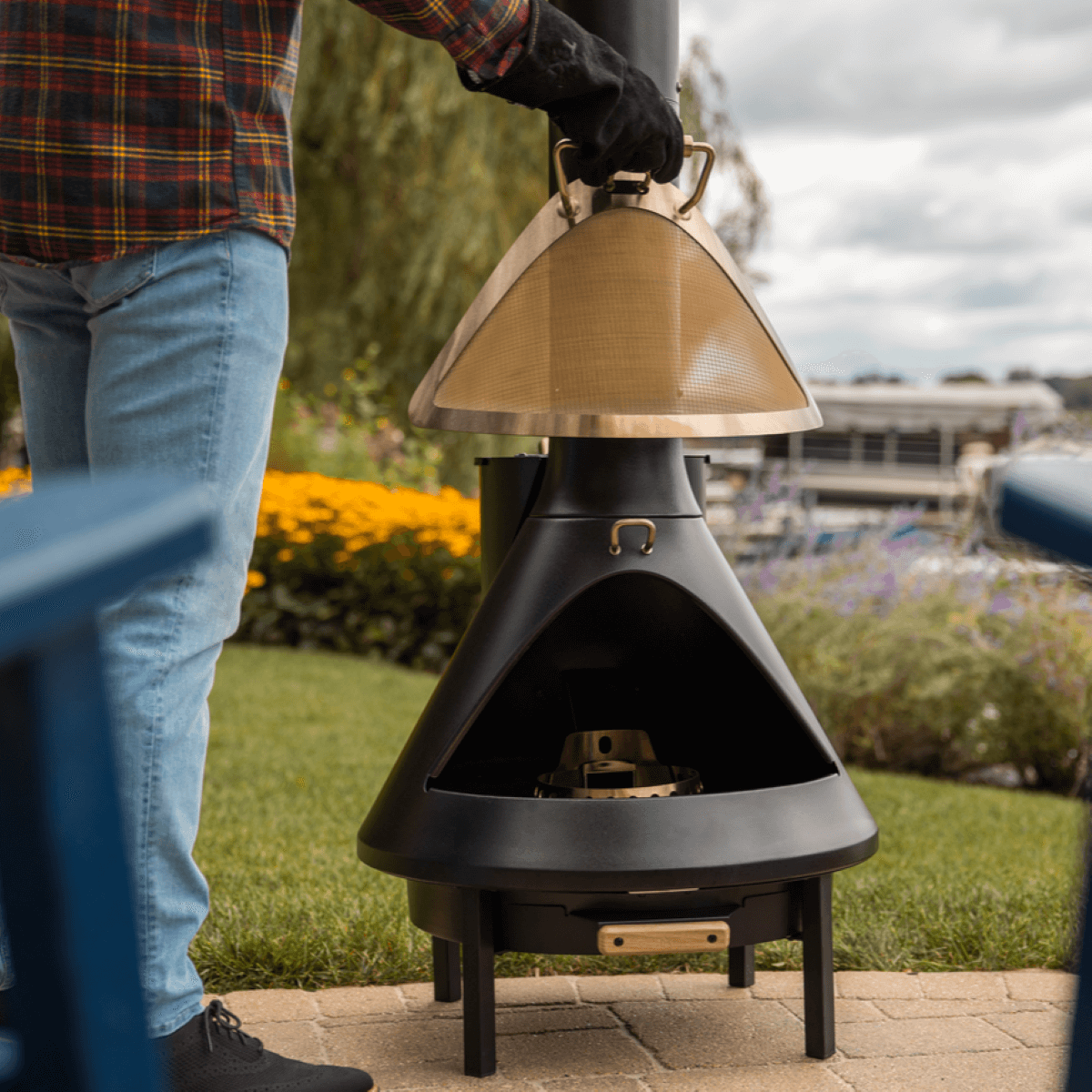 Black outdoor fire pit with lid, designed for outdoor use.