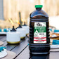 Black TIKI BiteFighter Citronella & Cedar Torch Fuel bottle with green cap.