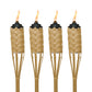 Set of four bamboo torches with black tops and lit flames.