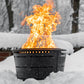 Black fire pit with roaring flames in snowy outdoor setting.