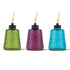 Colorful glass oil lamps in green, purple, and blue with flames.