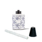 White candle holder with blue geometric pattern, black lid, and white taper candle.
