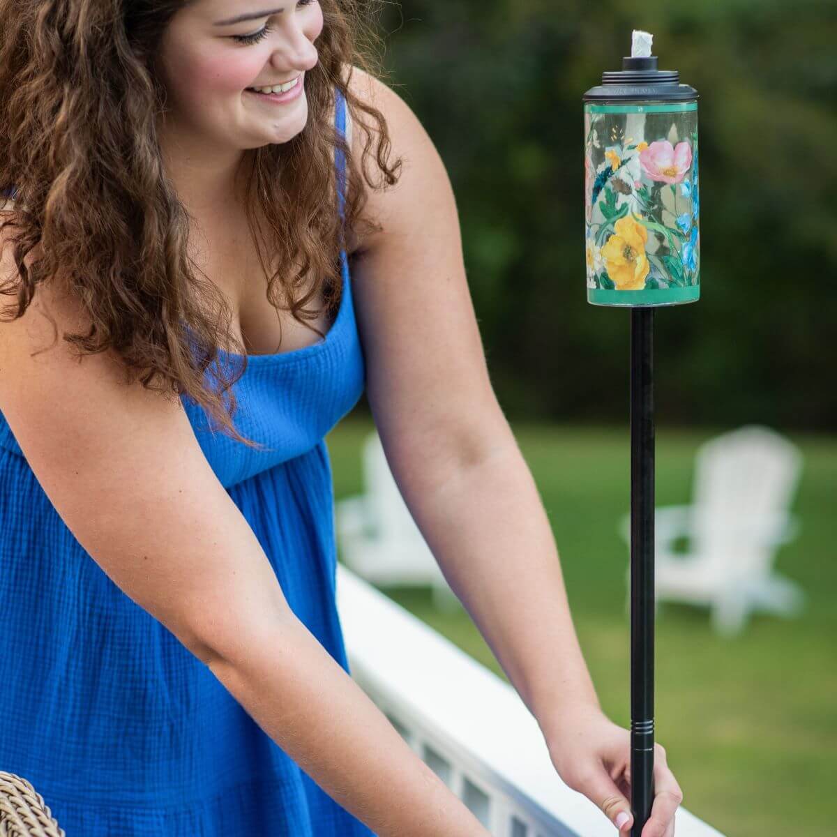 Green floral-patterned tiki torch with black pole.