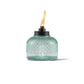 Green glass oil lamp with flame, Tiki brand.