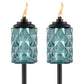 Set of two teal glass tiki torches with diamond pattern, black tops, and visible flames. Ideal for outdoor lighting.