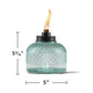 Turquoise glass oil lamp with flame, 5 3/4" tall, 5" wide.