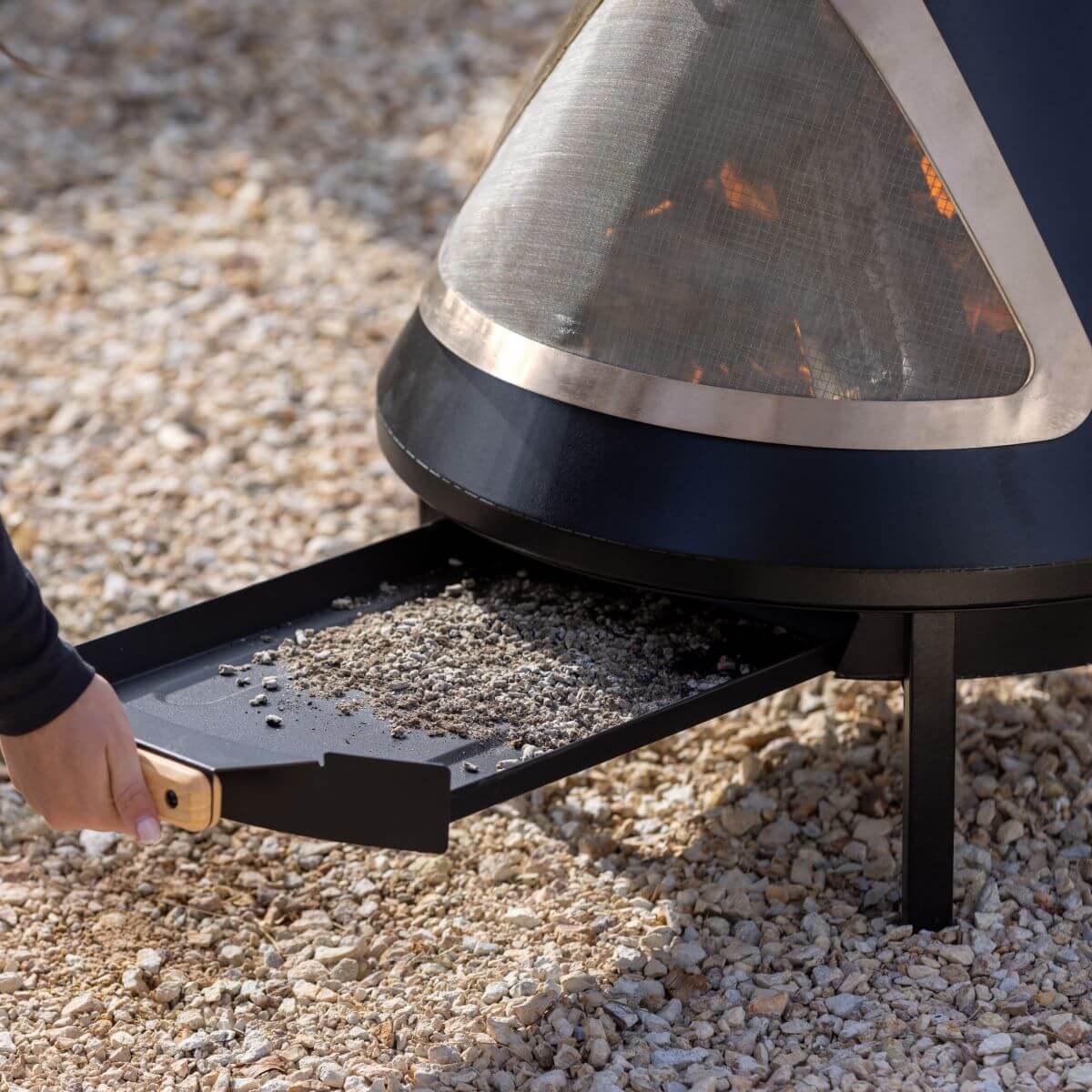 Modern black and silver fire pit with ash tray, outdoor use.