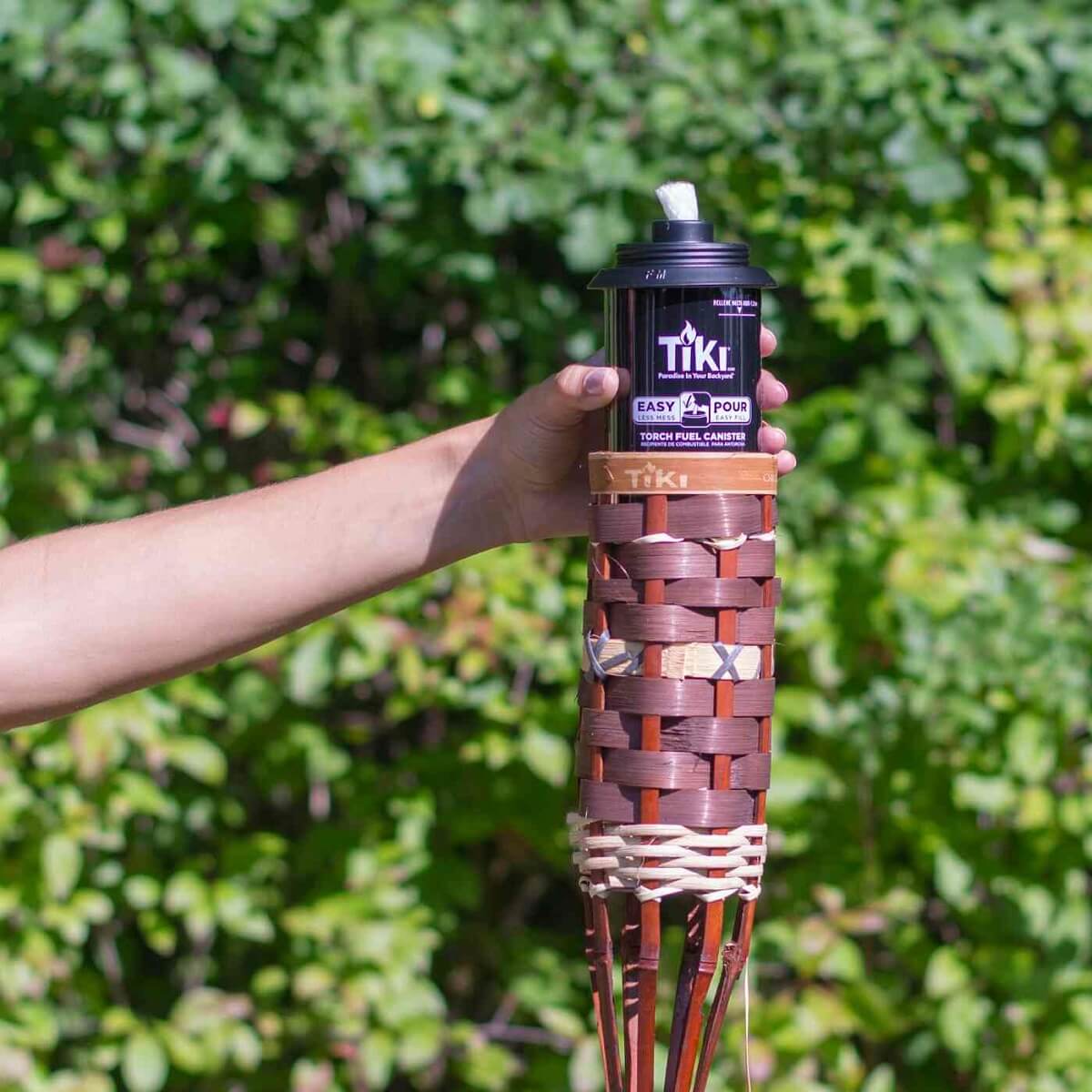 Black TIKI torch fuel canister with woven torch base.