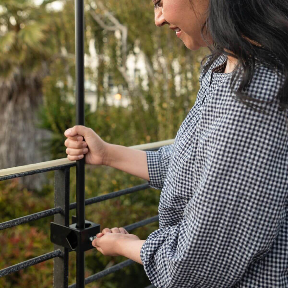 Black metal railing with adjustable post bracket for balcony or deck.