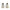 White Tiki torches with green leaf pattern and gold trim, lit.
