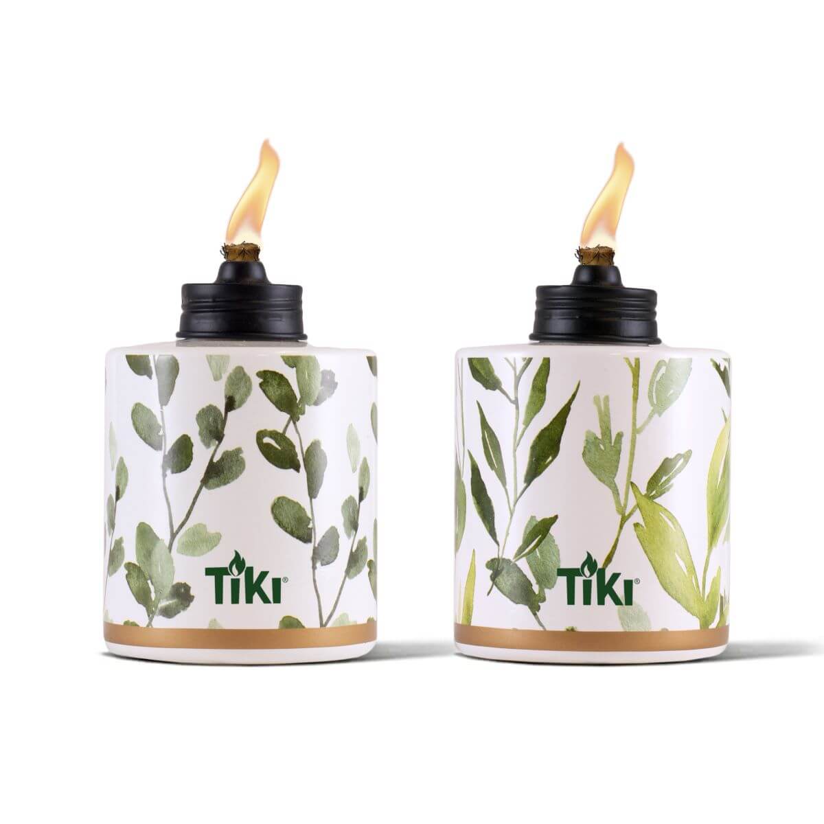 White Tiki torches with green leaf pattern and gold trim, lit.