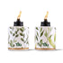 White Tiki torches with green leaf pattern and gold trim, lit.