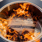 "Wood Pack real wood pellets instant light, burning in a grill."